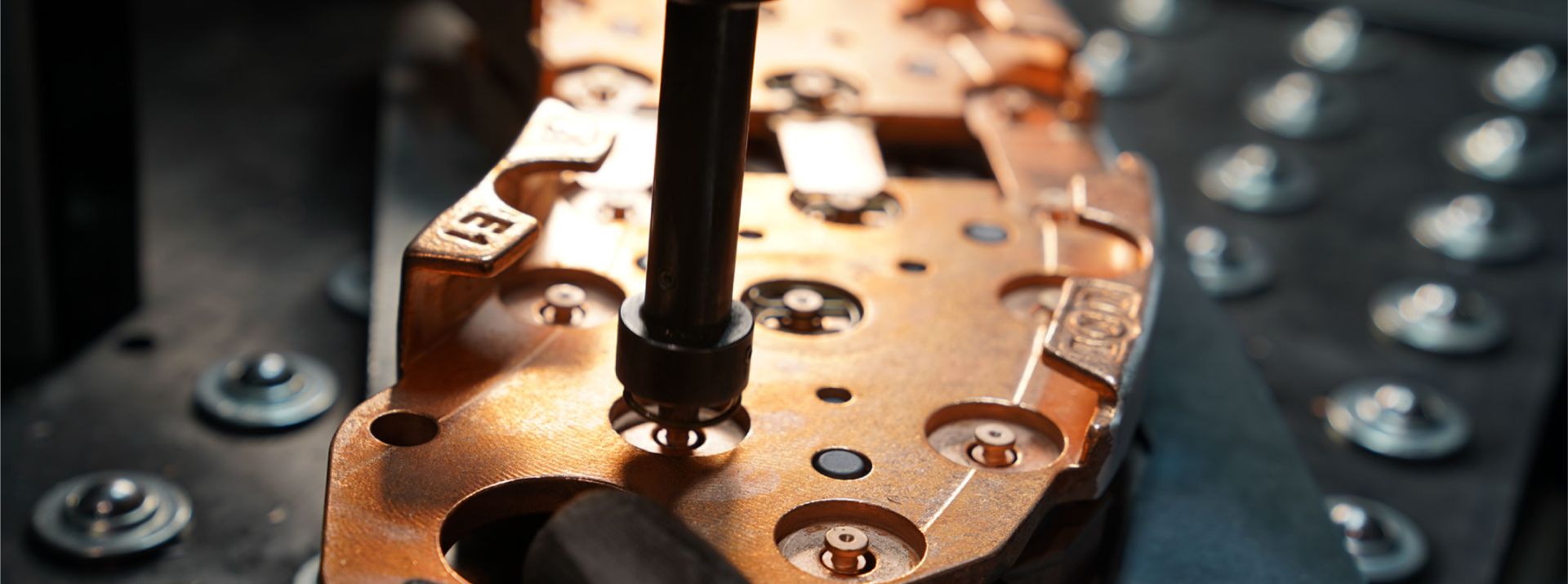 Copper component being assembled in manufacturing process.